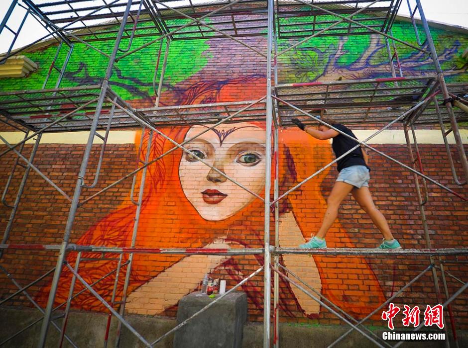 Graffiti artists paint on street walls in Xinjiang