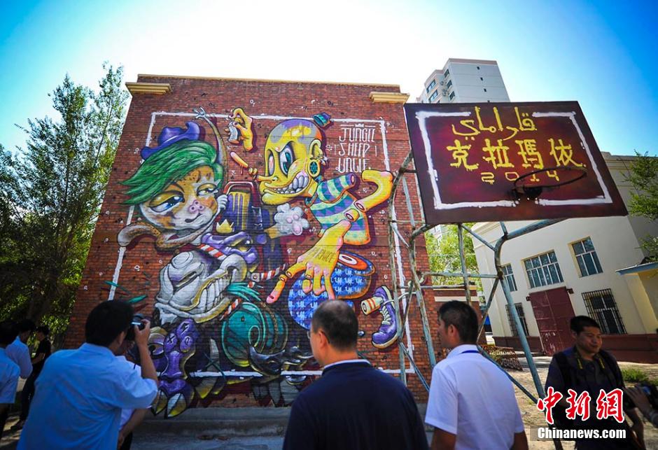 Graffiti artists paint on street walls in Xinjiang