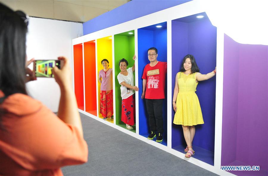 Visitors create their own photos at photo studio exhibition in Beijing