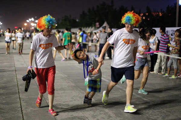 Runners sprint past Beijing's iconic structures