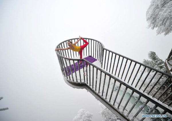 Women do yoga after snowfall