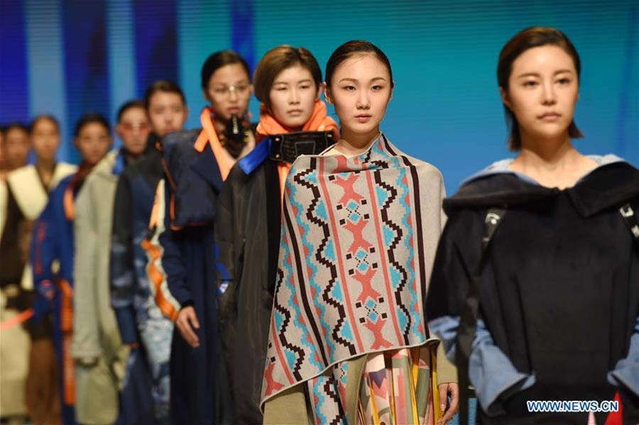 Models present fashion designs of graduates in Beijing