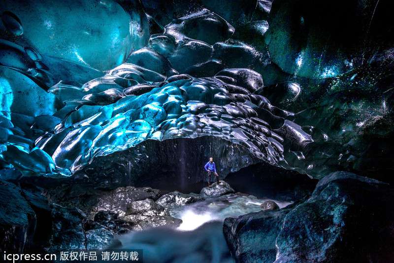 Amazing waterfall falls through ice caves