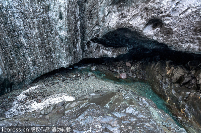 Amazing waterfall falls through ice caves