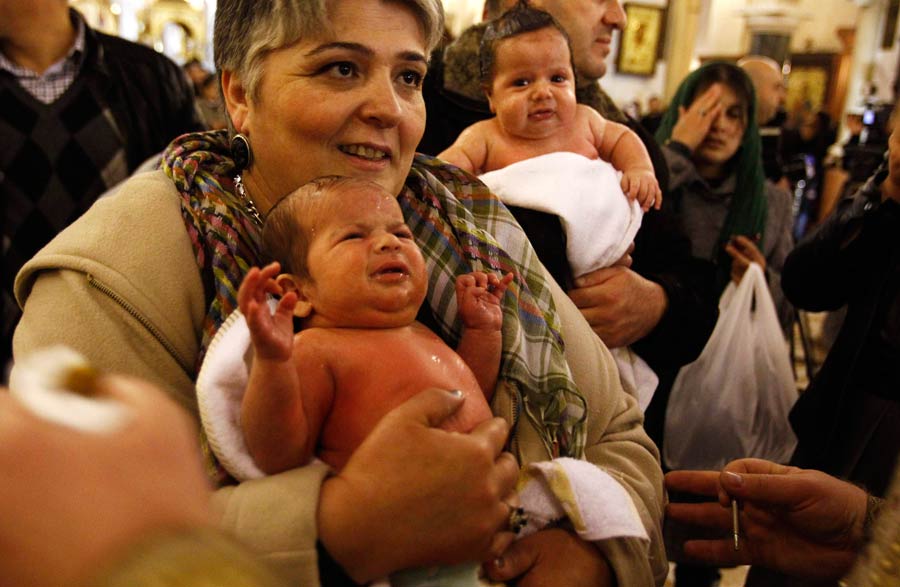 Babies baptised during a mass ceremony