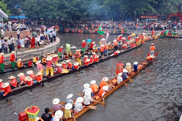 Participants compete in dragon boat races before Dragon Boat Festival