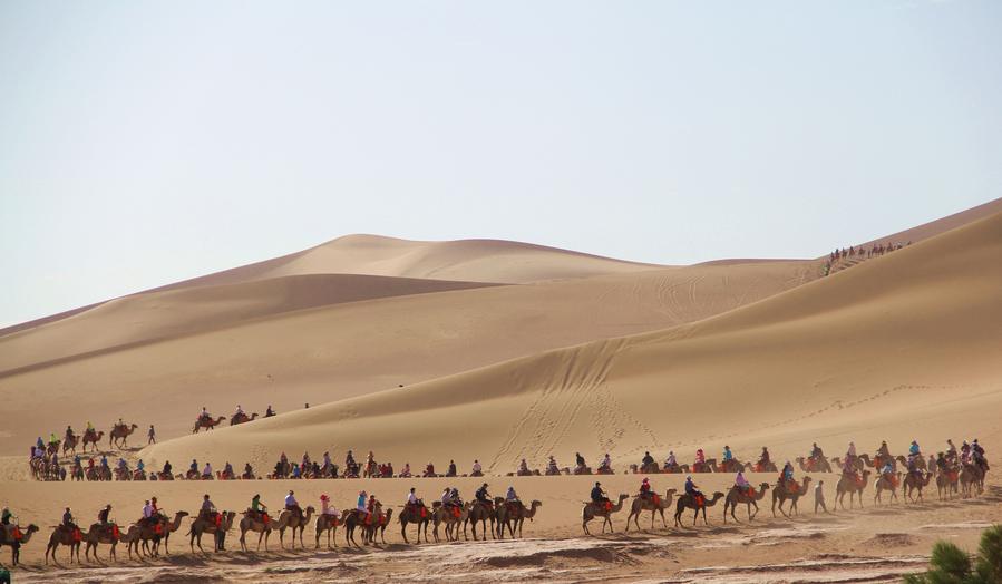 Tourists visit Mingsha Mountain in Dunhuang, NW China