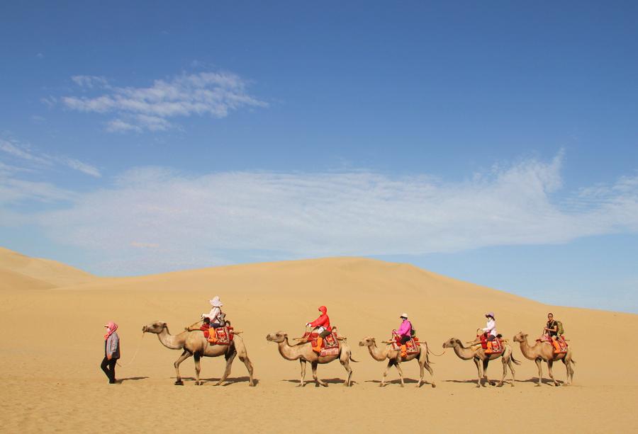 Tourists visit Mingsha Mountain in Dunhuang, NW China