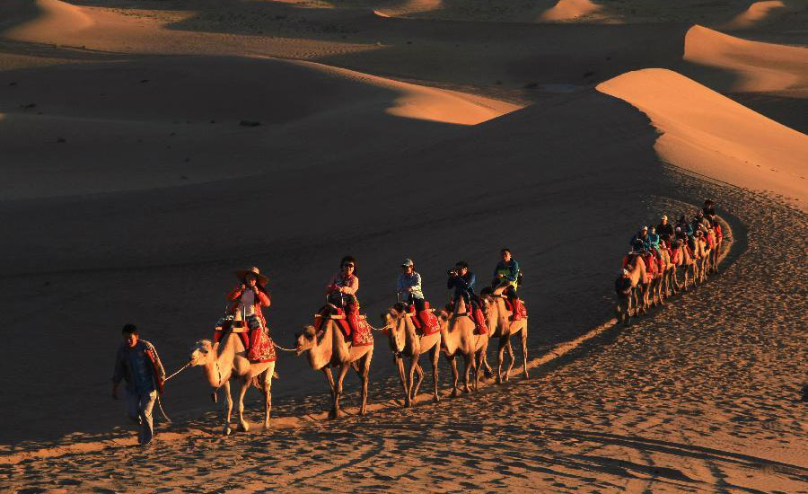 Tourists visit Mingsha Mountain in Dunhuang, NW China