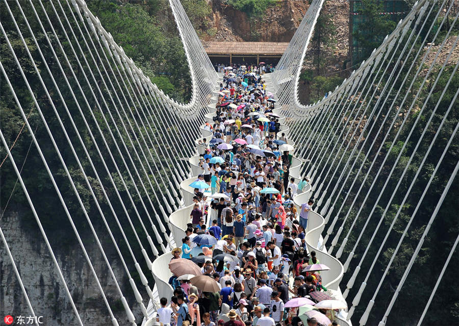 World's longest, highest glass bridge opens in Hunan