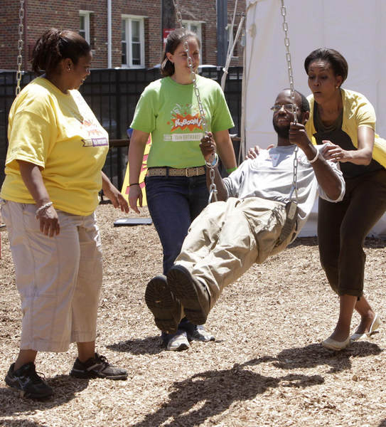 US first lady joins volunteers to build playground