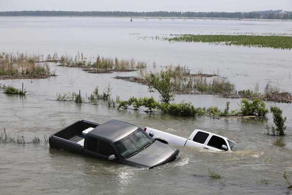 Flood surges over levees in Missouri