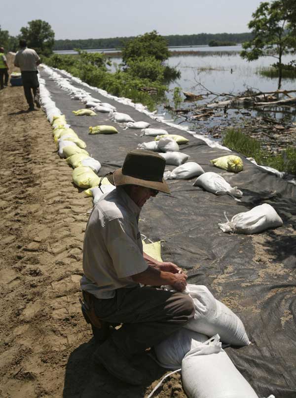 Flood surges over levees in Missouri