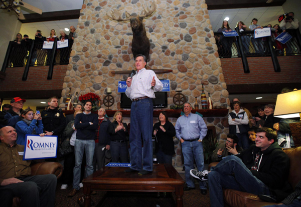 Romney leads Paul in Iowa poll, Santorum surges