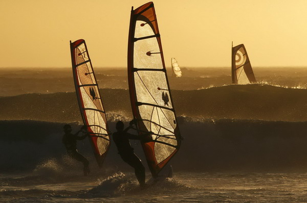 Windsurfers taking on waves in Cape Town