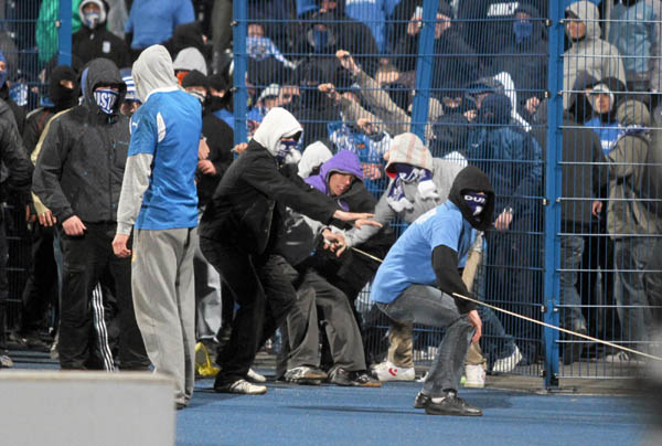 Polish hooligans undress player after match