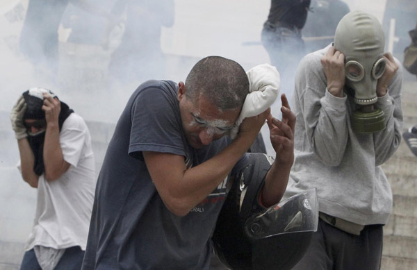 Greece passes steep cuts as riots seize capital