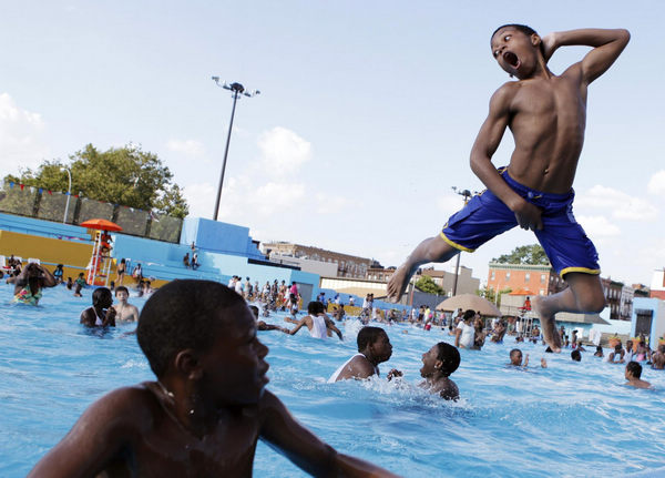 Dive into a pool amid summer heat