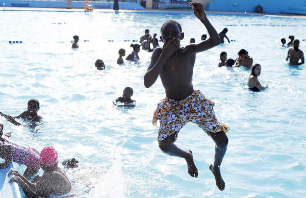 Dive into a pool amid summer heat