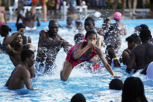 Dive into a pool amid summer heat