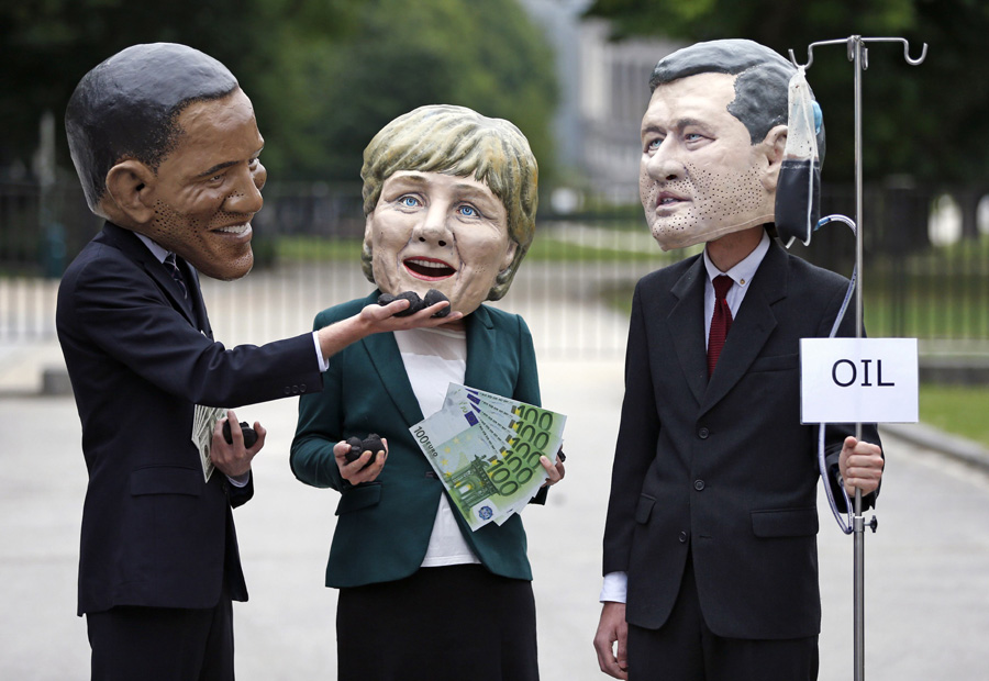 Oxfam demonstrators wearing masks of G7 leaders protest in Brussels