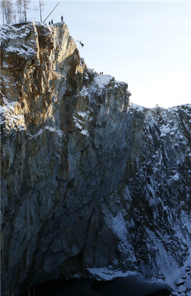 Rope-jumpers pictured leaping into crater