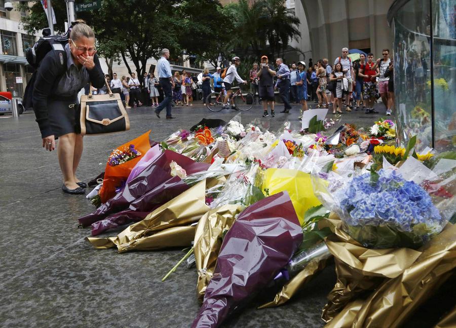 People pay floral tributes to Sydney siege victims