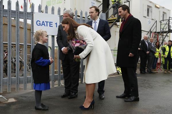 Pregnant Catherine adds color to racing headquarters in southern England