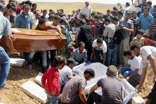 Drowned refugee boys buried in Syria; crackdown crumbles in Hungary