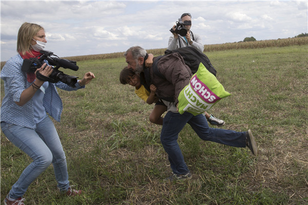 Hungarian TV journalist fired for tripping up fleeing migrants