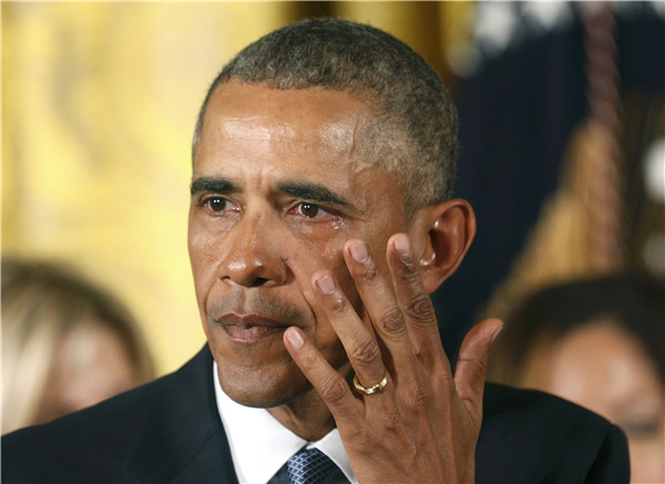 Obama, wiping tears, makes new push to tighten gun rules