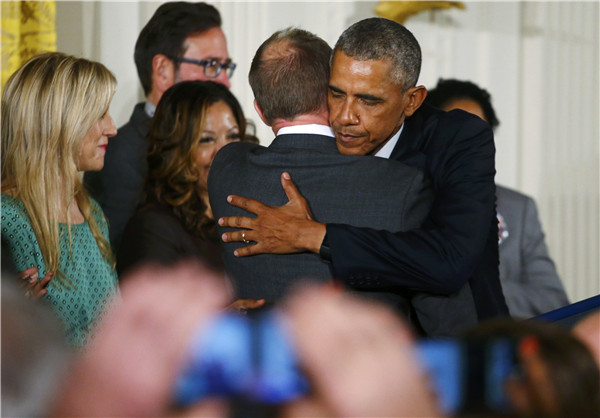 Obama, wiping tears, makes new push to tighten gun rules