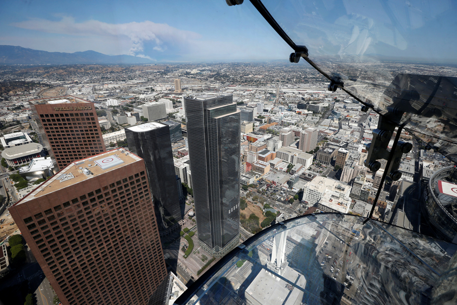 Woman rides skyslide 1000-feet above downtown Los Angeles