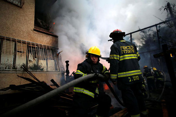 Tens of thousands flee fires as Israeli leaders blame Arab minority for arson