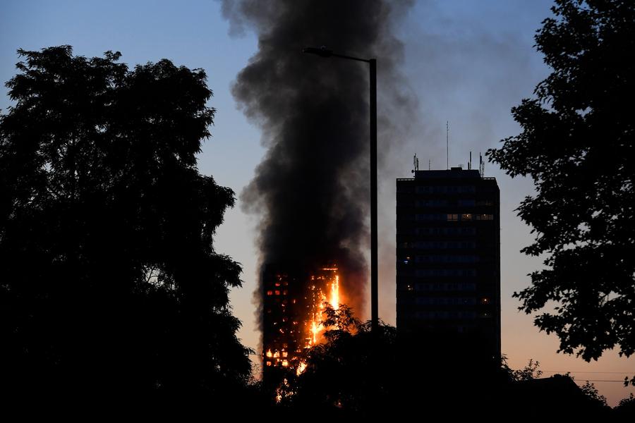 Fire engulfs London tower block, at least 12 dead