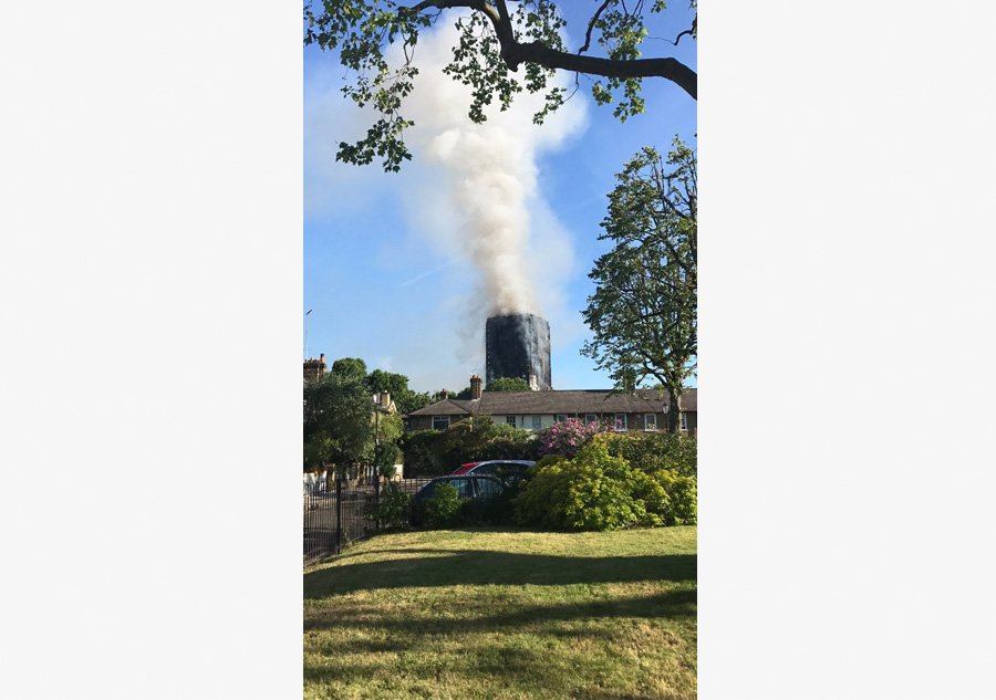 Fire engulfs London tower block, at least 12 dead