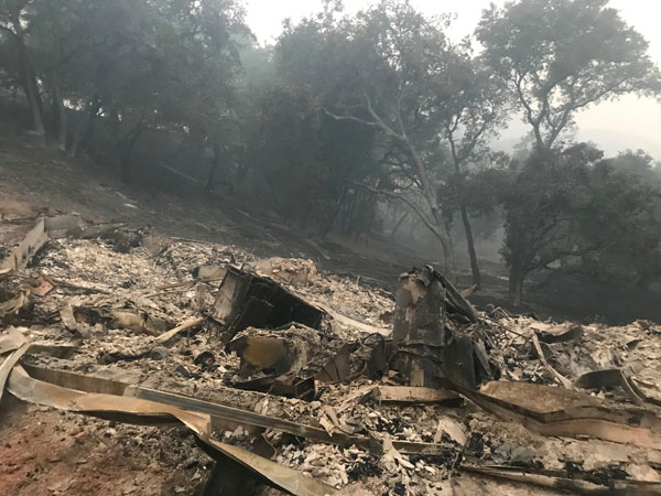 At least 21 dead, hundreds missing as winds fan California wildfires