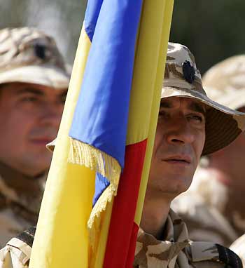 Romanian soldiers march during a turn-over ceremony in the Iraqi city of Kut, south of Baghdad December 19, 2005. More than 900 Ukrainian troops stationed in Iraq since 2003 are leaving while Polish,Romanian and Kazakhstan soldiers will take over the camp in Kut.