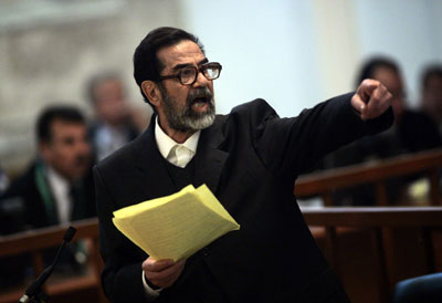 Former Iraqi President Saddam Hussein argues with prosecutors while testifying during cross-examination at his trial in Baghdad's Green Zone April 5, 2006. Hussein returned to court on Wednesday and, in remarks likely to inflame sectarian tensions, immediately accused the Iraqi Interior Ministry of killing and torturing thousands of Iraqis. [Reuters]