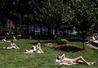 Sunbathers endure the heat in New York's Union Square park in this Tuesday July 18, 2006 file photo. (AP Photo/Frank Franklin II) 