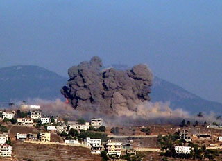 Smoke rises from Khiam village after being hit by Israeli air strikes, in southern Lebanon, July 25, 2006. 