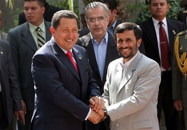 Iranian President Mahmoud Ahmadinejad (right) shakes hands with Venezuela's President Hugo Chavez, before an official welcoming ceremony for Chavez in Tehran, Iran , Saturday, July 29, 2006.[AP Photo]