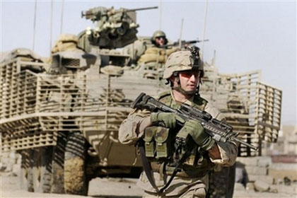 A U.S. Army 1st Battalion, 24th Infantry soldier walks ahead of an armored Stryker combat vehicle during a foot patrol, Sunday, Jan. 16, 2005, in Mosul, Iraq. The U.S. top commander in Iraq George W. Casey Jr. confirmed on Saturday it will send about 3,700 troops of the 172nd Stryker Brigade from northern Iraq to Baghdad to try to quell violence in the capital. (AP Photo