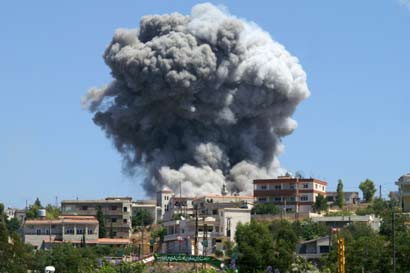 Smoke rises from Naqoura village near the U.N. headquarters in south Lebanon August 13, 2006 after an Israeli air raid on the area. 