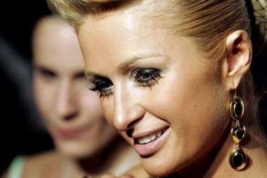 Paris Hilton talks to reporters as she arrives for an after party for the MTV Video Music Awards in New York, August 31, 2006. 