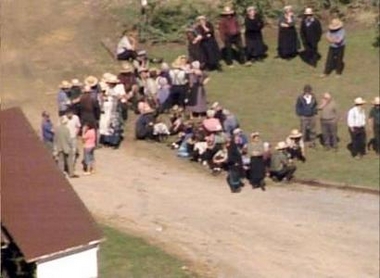 This still image taken from video shows members of an Amish community gathering near the scene of a schoolhouse shooting in rural Lancaster, Pennsylvania October 2, 2006. A gunman attacked the one-room Amish school in Pennsylvania on Monday, shooting and killing a number of people including an unknown number of students before he was captured or killed, police said. 