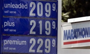 Gasoline prices are shown at a station in Indianapolis in this September file photo. A new study says Americans are burning nearly 1 billion more gallons of gasoline each year than they did in 1960 because of their expanding waistlines. (AP