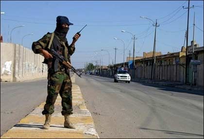 An Iraqi soldier guards at a checkpoint during curfew in the restive city of Baquba. Iraq's beleaguered armed forces have been ordered onto high alert ahead of the verdict in the trial of ousted dictator Saddam Hussein, while a US spy chief made an unannounced visit to Baghdad.(