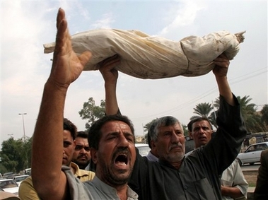 Iraqis hold up a mock corpse to symbolize Saddam Hussein's crimes against Shiites as they celebrate as the death sentence verdict for former leader Saddam Hussein is known, in Najaf, 160 kilometers (100 miles) south of Baghdad, Sunday, Nov. 5, 2006. Iraq's High Tribunal on Sunday found Saddam Hussein guilty of crimes against humanity and sentenced him to hang, as the visibly shaken former leader shouted 'God is great!' (AP