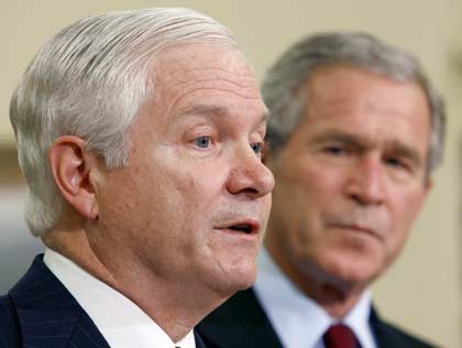 .S. President George W. Bush (L) listens to Robert Gates speak after Bush announced that Gates will replace Donald Rumsfeld as Secretary of Defense at the White House in Washington November 8, 2006. Rumsfeld, the controversial face of U.S. war policy, quit on Wednesday after Democrats rode Americans' anger and frustration over Iraq to victory in Tuesday's congressional elections. 